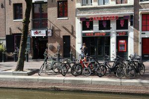 Bicycles parked along a canal in front of an erotic theatre