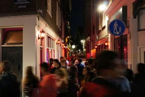 Crowded alley in the red light district by night