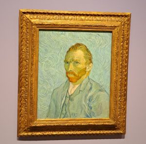 A painting of Vincent van Gogh in a frame