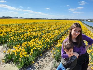 two children posing in a yellow field of flowers