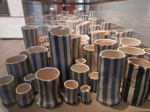 Striped vases in a glass display case
