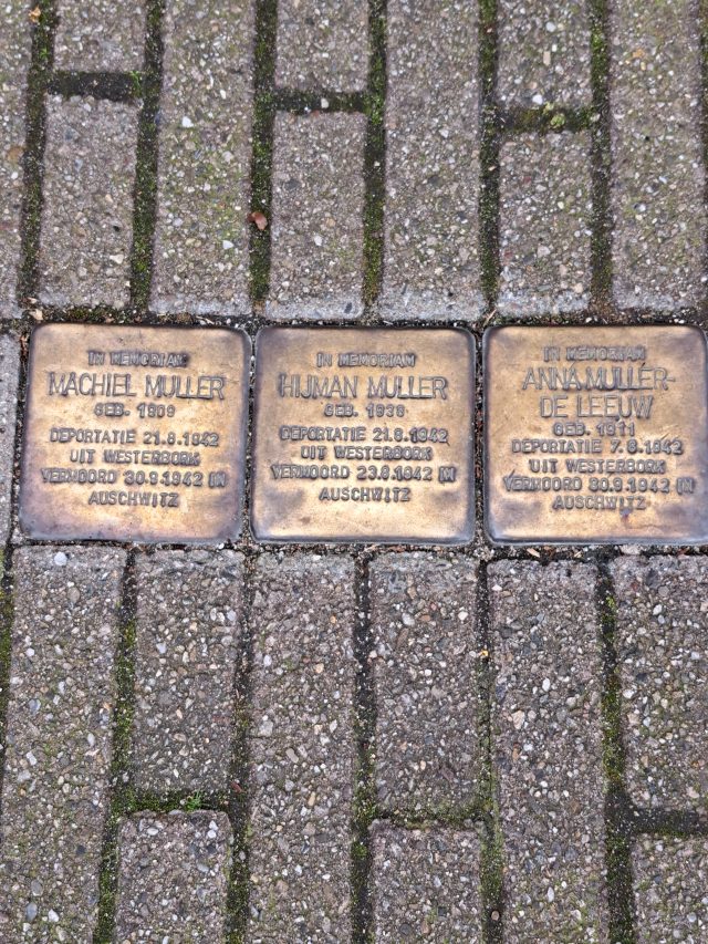 Three square brass plates in the pavement, inscribed with names and dates
